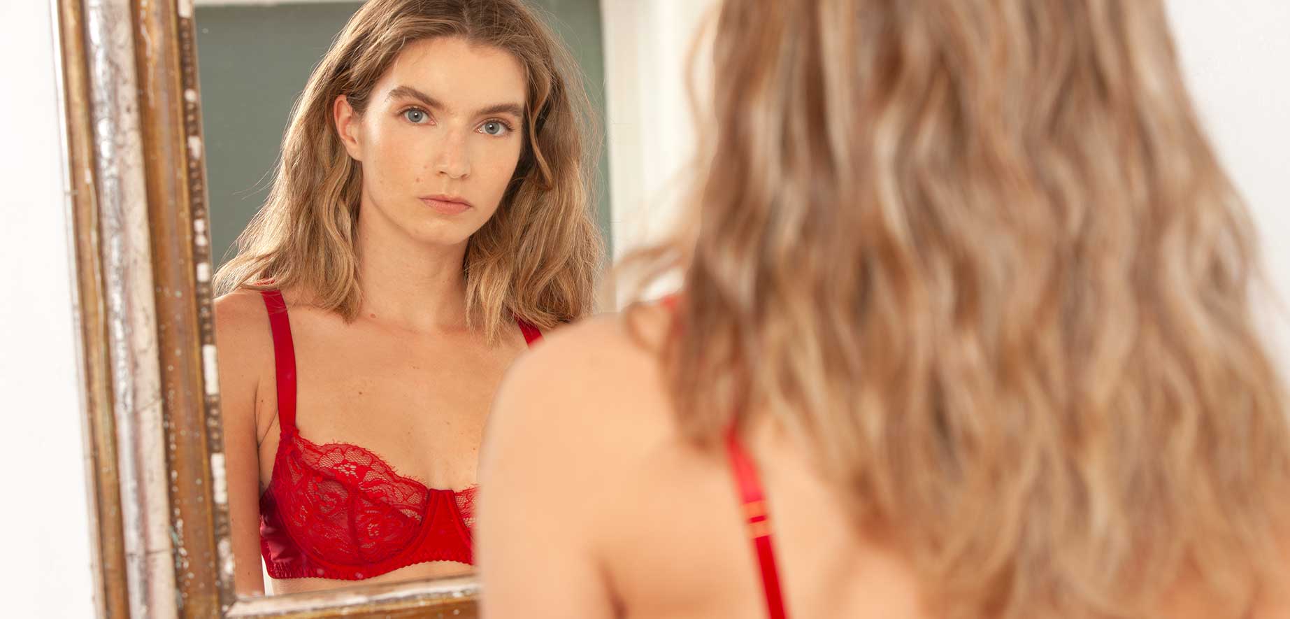 Model wearing Fleur of England red balcony lingerie bra