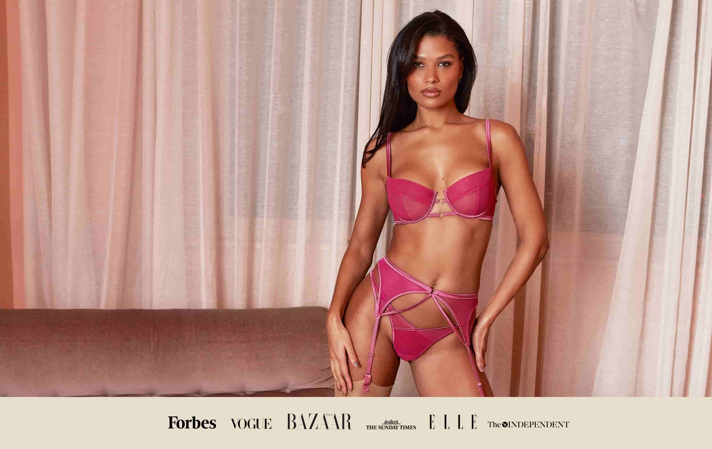 Model wears Luxury Pink Demi Bra, Thong and Suspender Belt Set by Fleur of England