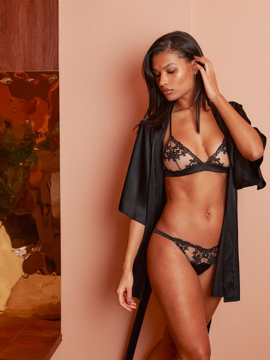 Woman wears Onyx non-wired boudoir bra with ouvert brief lingerie set with silk robe