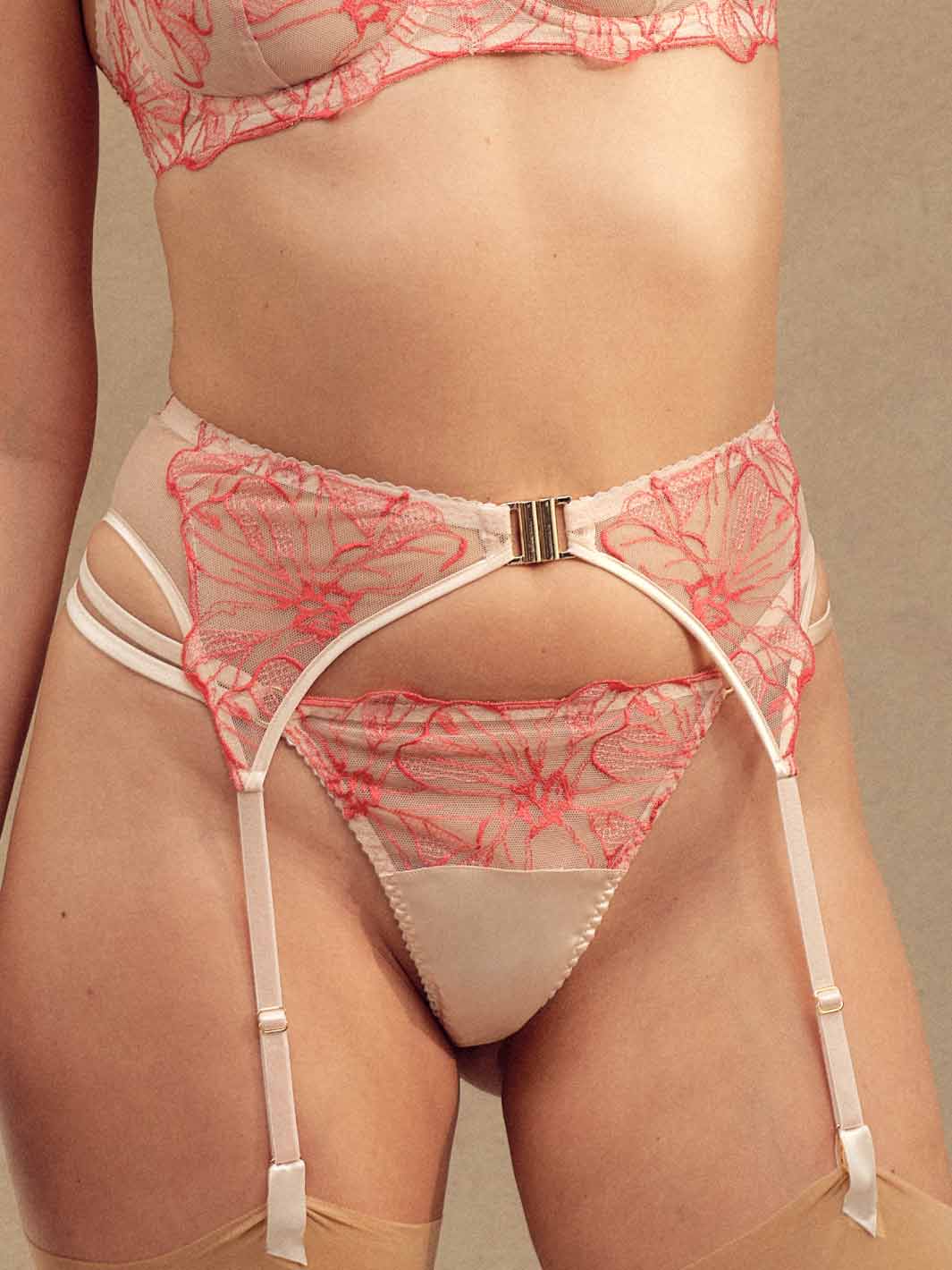 Front view of Model wearing luxury Pink and Red Floral Design Silk and Tulle Suspender Belt by Fleur of England