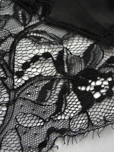 Close up image of black luxury lace with floral detailing by Fleur of England