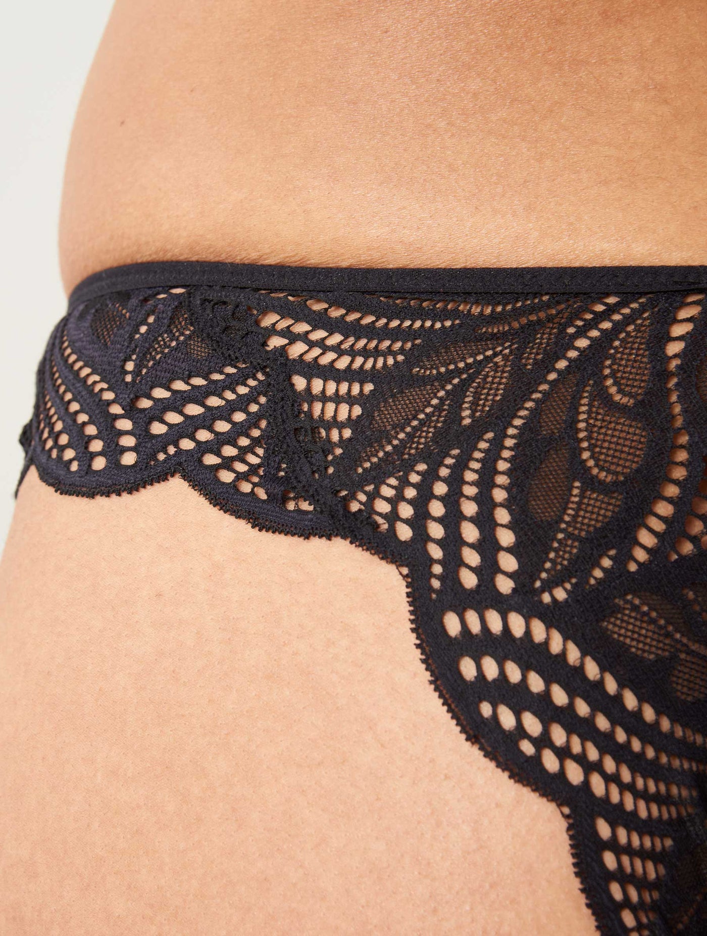 Close up image of navy, lace details in the Deilen brazilian brief.