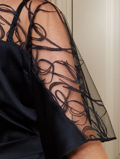 Close up image of detailed brush stroke embroidery on the sheer sleeves of the Fridar Silk Robe.