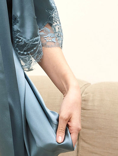 Close up image of the blue silk and lace details in the Ocean robe.